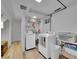 Functional laundry room with modern appliances, ample shelving, and wood-look flooring at 595 W Lake Ave, Littleton, CO 80120