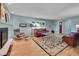 Comfortable living room with fireplace, large window, hardwood floors, and contemporary decor at 595 W Lake Ave, Littleton, CO 80120