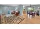 Bright living room with hardwood floors and a dining area, ideal for modern living at 595 W Lake Ave, Littleton, CO 80120