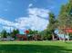 Vibrant playground with various play structures and a swing set, perfect for Gathering fun and recreation at 595 W Lake Ave, Littleton, CO 80120
