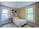 Bright bedroom with two windows, a ceiling fan, and light yellow walls at 2507 9Th St, Boulder, CO 80304