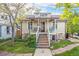 Home featuring a covered front porch with modern railings, beautiful stone accents and a well-kept lawn at 2507 9Th St, Boulder, CO 80304