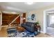 Comfortable living room featuring wood floors, a blue rug, and a staircase, creating a warm and inviting space at 2507 9Th St, Boulder, CO 80304