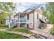 Exterior view with a small porch, stone accents, and lovely landscaping with a walking path in the backyard at 2507 9Th St, Boulder, CO 80304
