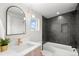 Modern bathroom features a deep soaking tub, dark tiled walls, and a stylish vanity at 2538 S Acoma St, Denver, CO 80223