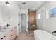 Bathroom featuring a soaking tub, glass shower, and a vanity with a vessel sink at 2538 S Acoma St, Denver, CO 80223