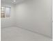 This bedroom features neutral paint, a window, and plush carpeting at 2538 S Acoma St, Denver, CO 80223