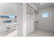 Walk-in closet with custom shelving and a view into the adjacent bedroom at 2538 S Acoma St, Denver, CO 80223