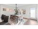 Bright dining room with hardwood floors, stylish rug, contemporary lighting, and large windows at 2538 S Acoma St, Denver, CO 80223