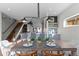 Contemporary dining room with a wooden table set with blue placemats under a modern chandelier at 2538 S Acoma St, Denver, CO 80223