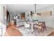 Open concept dining room with wood floors, modern lighting, and seamless flow to the kitchen at 2538 S Acoma St, Denver, CO 80223