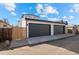 Two car garage with concrete driveway and modern design at 2538 S Acoma St, Denver, CO 80223