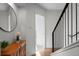 Bright hallway with hardwood floors, a staircase, and a console table with decorative vases at 2538 S Acoma St, Denver, CO 80223