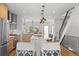 Bright open concept kitchen with an island, stainless steel appliances, and a view of the staircase at 2538 S Acoma St, Denver, CO 80223