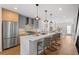 Contemporary kitchen boasts stainless steel appliances, center island, and pendant lighting, creating an inviting space at 2538 S Acoma St, Denver, CO 80223
