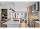 Open concept kitchen showcasing island seating, stainless appliances, and adjacent living area at 2538 S Acoma St, Denver, CO 80223