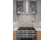 Chef's kitchen featuring a stainless steel range, stylish backsplash, and modern design, for ultimate cooking experience at 2538 S Acoma St, Denver, CO 80223