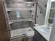 Bathroom featuring gray tile shower with glass doors and modern vanity at 4247 S Pitkin St, Aurora, CO 80013