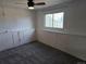 Bedroom with neutral carpet features paneling, a ceiling fan and a large window at 4247 S Pitkin St, Aurora, CO 80013