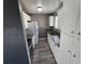 Galley kitchen with stainless appliances, gray counters, and white cabinets at 4247 S Pitkin St, Aurora, CO 80013