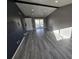 Spacious living room with vaulted ceiling and new gray flooring at 4247 S Pitkin St, Aurora, CO 80013