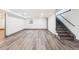 Spacious basement with durable laminate flooring and a staircase leading to the upper level at 1112-1112 1/2 Krameria St, Denver, CO 80220