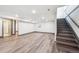 Spacious basement featuring durable laminate flooring and a staircase leading to the upper level at 1112-1112 1/2 Krameria St, Denver, CO 80220