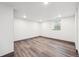 Finished basement with laminate floors, neutral paint, and natural light at 1112-1112 1/2 Krameria St, Denver, CO 80220