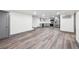 Spacious basement with durable laminate flooring leading to kitchen and stairs to the upper level at 1112-1112 1/2 Krameria St, Denver, CO 80220