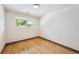 Serene bedroom with hardwood floors and a large window for natural light at 1112-1112 1/2 Krameria St, Denver, CO 80220