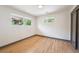 Bright bedroom with hardwood floors and two windows, offering ample sunlight at 1112-1112 1/2 Krameria St, Denver, CO 80220
