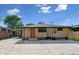 Charming single-story home featuring a beautiful brick exterior, well-manicured lawn, and a cozy front porch at 1112-1112 1/2 Krameria St, Denver, CO 80220