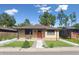 Quaint home featuring fresh landscaping and a welcoming front entrance at 1112-1112 1/2 Krameria St, Denver, CO 80220