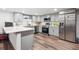 Modern kitchen boasts stainless steel appliances and gray cabinetry at 1112-1112 1/2 Krameria St, Denver, CO 80220