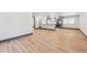 Open concept living space with hardwood floors and a view into the kitchen at 1112-1112 1/2 Krameria St, Denver, CO 80220