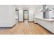 Bright, airy living space with hardwood floors and kitchen access at 1112-1112 1/2 Krameria St, Denver, CO 80220