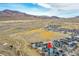 Aerial view of the community in a valley with mountains at 15794 W Girard Ave, Morrison, CO 80465