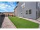 Backyard features an artificial lawn bordered by decorative rocks at 15794 W Girard Ave, Morrison, CO 80465
