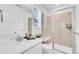 Modern bathroom with a glass shower stall, white vanity, and neutral tile at 15794 W Girard Ave, Morrison, CO 80465