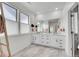 Bright bathroom with a double sink vanity, large mirror, marble floors, and stylish fixtures at 15794 W Girard Ave, Morrison, CO 80465