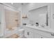 Well-lit bathroom featuring dual sinks, a tub with a shower, and contemporary fixtures at 15794 W Girard Ave, Morrison, CO 80465