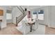 Bright dining area with wood table, white chairs, and a view of the modern staircase at 15794 W Girard Ave, Morrison, CO 80465