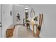 Inviting entryway with natural light, wood floors, bench, and console table with skis at 15794 W Girard Ave, Morrison, CO 80465
