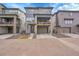 Modern three-story home with a stone accent facade, balcony, and two-car garage at 15794 W Girard Ave, Morrison, CO 80465