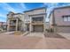 Modern three-story townhome featuring a stone accent facade, balcony, and a two-car garage at 15794 W Girard Ave, Morrison, CO 80465