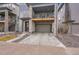 Exterior view of a gray three-story townhouse with a front-facing two car garage at 15794 W Girard Ave, Morrison, CO 80465