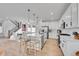 Open kitchen and dining area featuring a large island, stainless appliances, and wood floors at 15794 W Girard Ave, Morrison, CO 80465