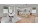 Bright, open-concept kitchen and dining area with modern white cabinetry and a large center island at 15794 W Girard Ave, Morrison, CO 80465