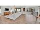 Bright open-concept living room features wood floors, white sofa, and sliding glass doors at 15794 W Girard Ave, Morrison, CO 80465