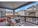 Covered patio with comfortable seating, a fire pit, and views of the surrounding neighborhood at 15794 W Girard Ave, Morrison, CO 80465